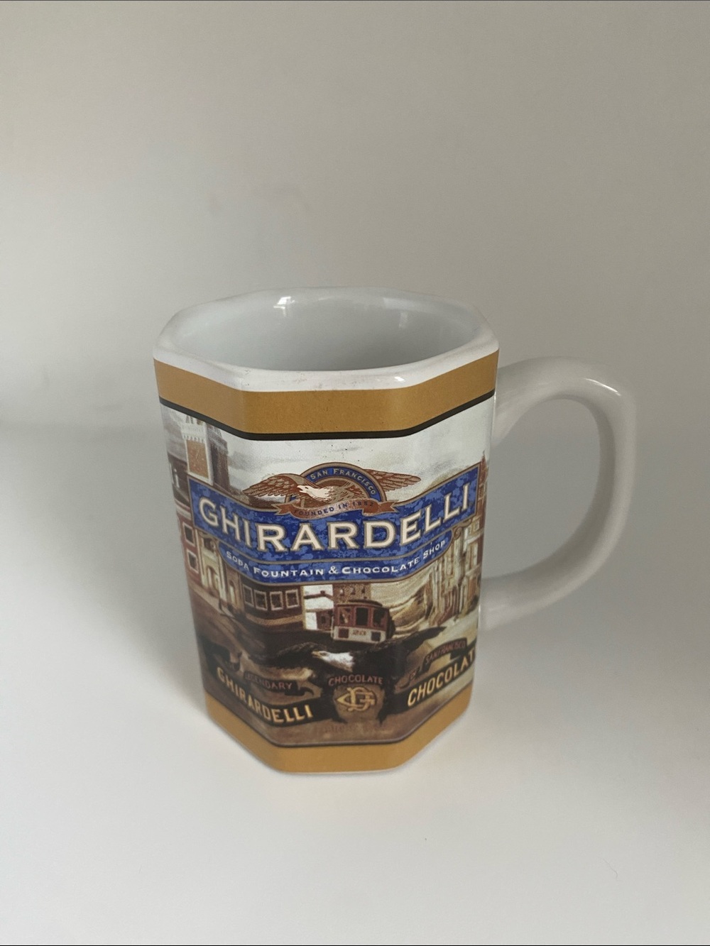 Ardell White, Gold brown and Blue Ghirardelli Logo Ceramic Mug